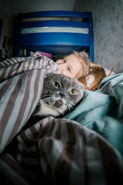 A girl and a cat at bedtime
