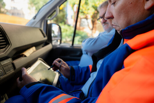 Paramedic using tablet in ambulance