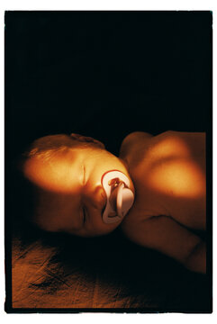 Baby peacefully sleeping with pacifier