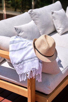 Hat and towel on outdoor lounge sofa relaxing vacation
