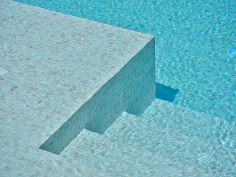 Swimming pool steps with radiant blue clear water