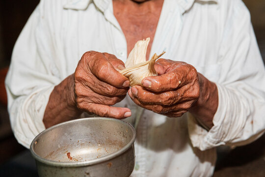 Elderly hands carefully folding food wrapper