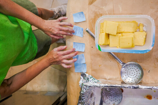 Person Preparing Polenta fries With Notes in a Kitchen 