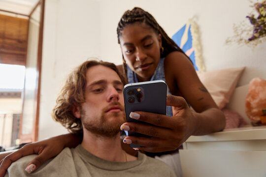 Looking at a phone together during a quiet moment
