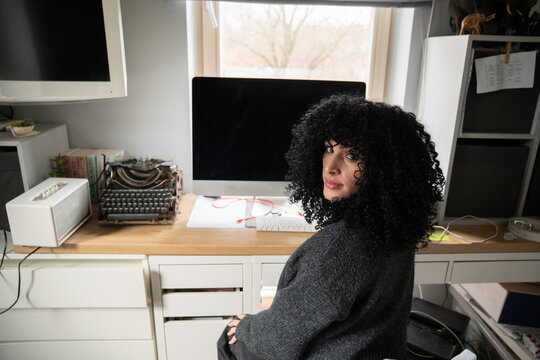 Woman working in a cozy home office with technology