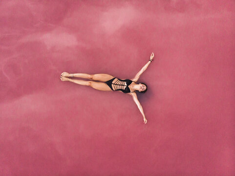 Woman floating on the stunning Pink Lake in Torrevieja