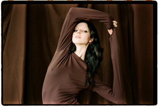 Woman posing in brown ribbed dress