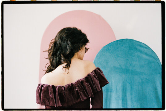 Back view fashion portrait with pastel shapes