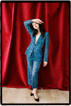 Model posing in blue lace suit