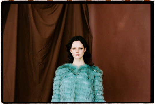 Woman in teal fur jacket