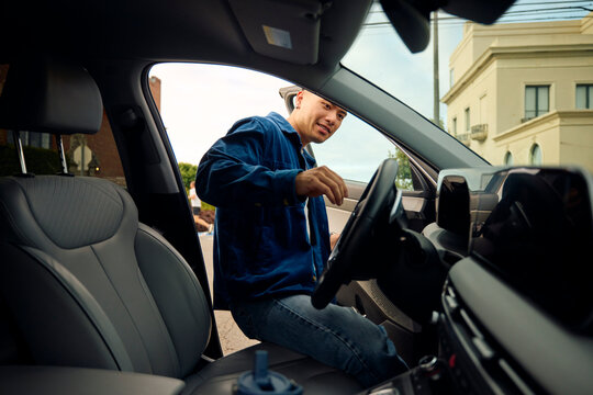 Man with a smile gets into his car