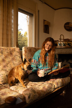 Woman reading with dog