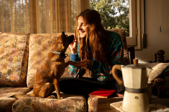 Woman feeding small dog