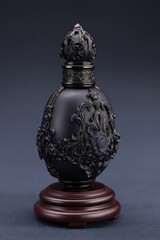 Ornate Black Perfume Bottle With Gold Accents On Wooden Stand