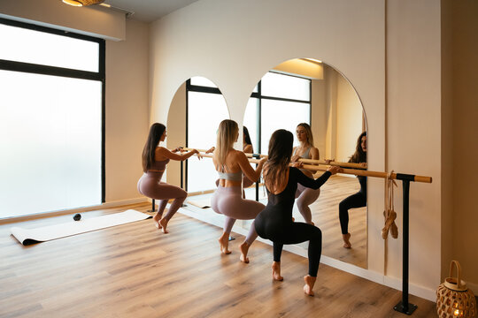 Women doing barre workout in fitness studio class
