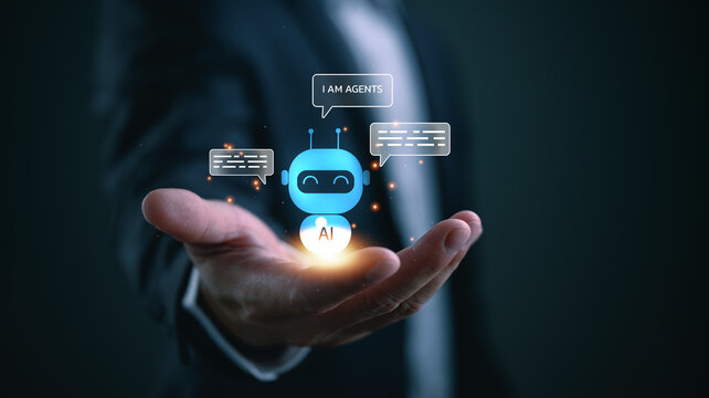 Businessman hand holding virtual AI chatbot robot icon with speech bubbles. Innovative artificial intelligence agent, customer service automation, and smart technology assistance concept.