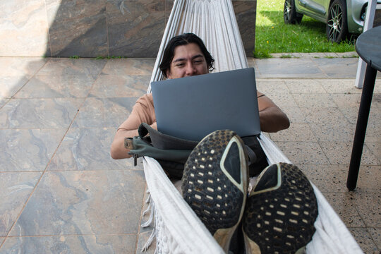 Working on a Laptop While Relaxing in a Hammock Outdoors