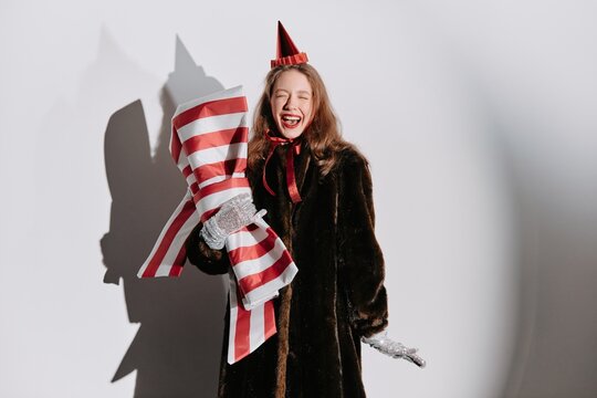 Happy woman holding fancy gift and laughing