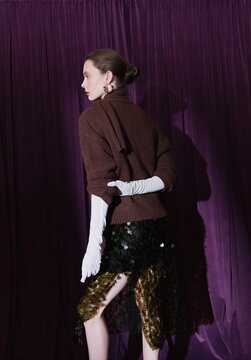 Fashion studio portrait of woman in evening outfit