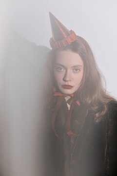 Portrait of unemotional woman in party hat 
