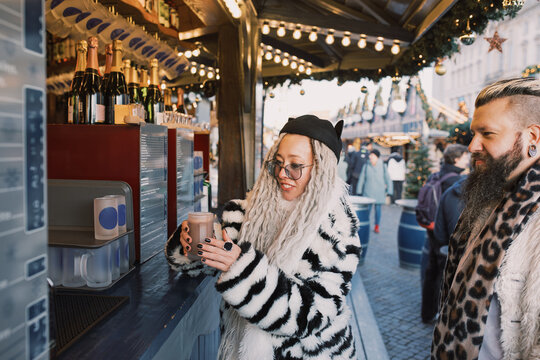 Couple Ordering Drinks at a Festive Christmas Market Bar