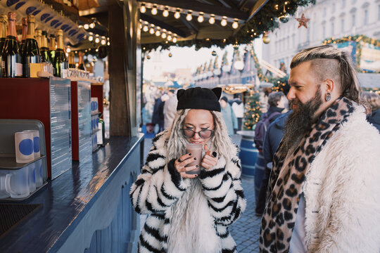Couple Ordering Drinks at a Festive Christmas Market Bar