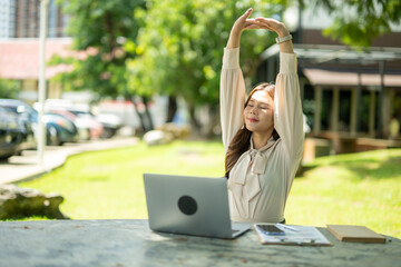 Businesswoman stretching outdoors during freelance work break