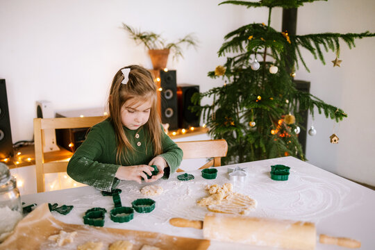 The child is making cookies.
