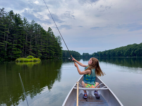 Girl fishing at lake summer vacation 