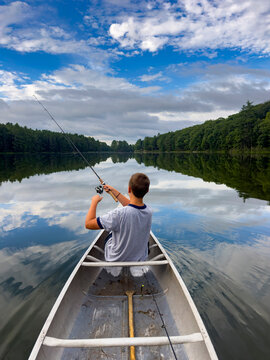 Young boy fishing  lake landscape 