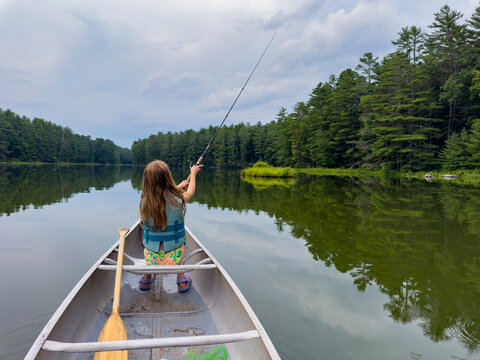 Young girl fishing at lake 