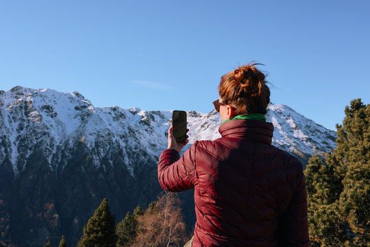 Tourist Takes a Selfie With Mountains view