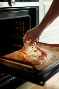 Adding Cheese to Homemade Pizza Before Baking