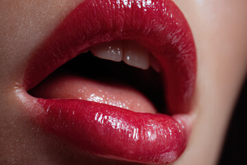 Obraz premium Close up of glossy red lips with shiny lipstick for glamour beauty and fashion cosmetic advertising concepts