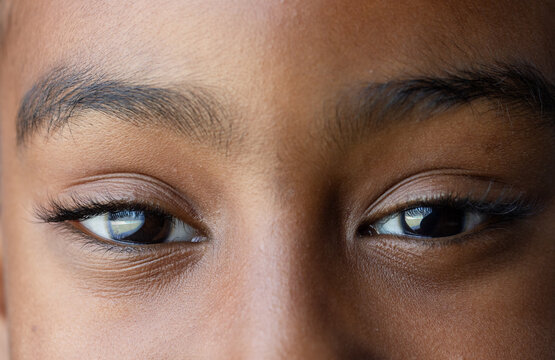 Eye area is showing mascara-coated lashes and eyeliner, reflecting rectangular window light
