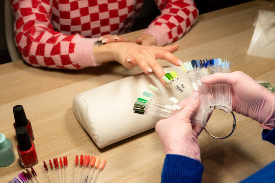 Color selection for nail art at a beauty salon in evening light