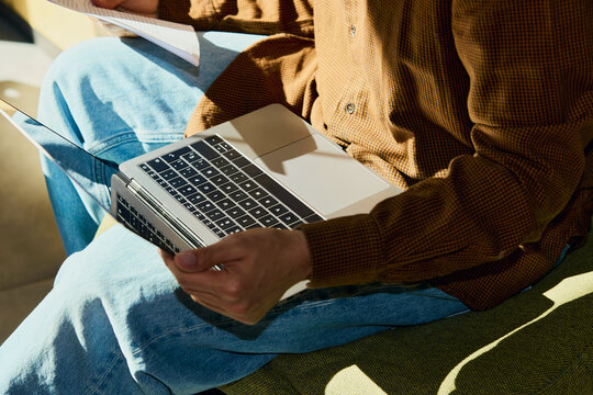 Remote worker seated with laptop in shared workspace