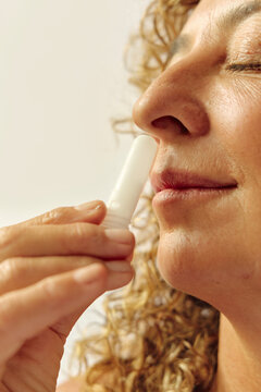 Woman smelling an essential oil aromatic  stick aromatherapy closeup
