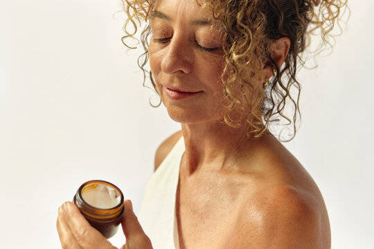 Woman holding a cosmetic cream product minimalist and natural mood