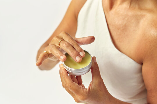 Woman applying a cosmetic cream beauty and skincare closeup