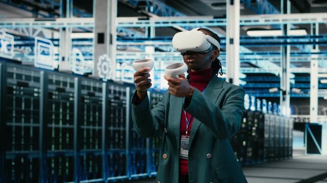 Data center system administrator uses VR headset gear and AR simulation to manage database storage rigs. Cloud computing server room worker uses virtual reality technology VFX visualization, camera B