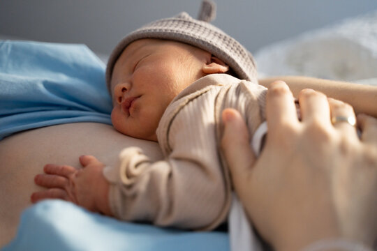 Newborn resting on mother&rsquo;s chest in hospital after delivery
