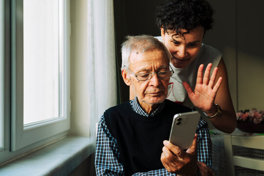 Grandfather and granddaughter making a video call 