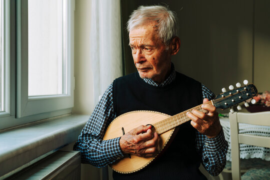 Senior man playing a mandolin