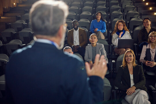 Man interacts with the crowd at the seminar