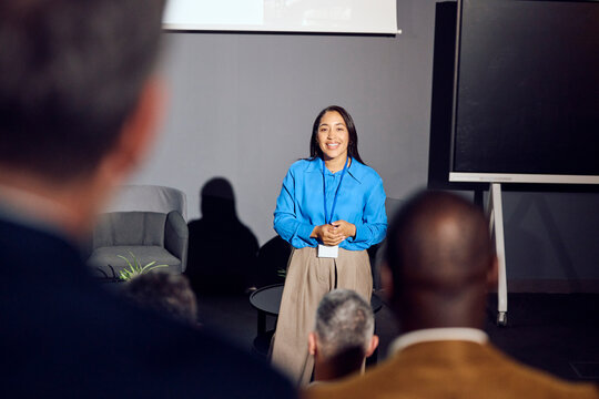 Woman speaks at a forum