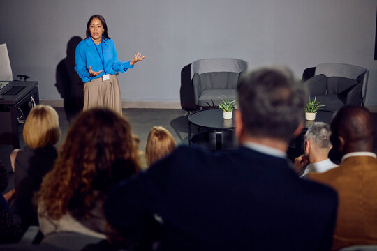 Woman speaks at a forum