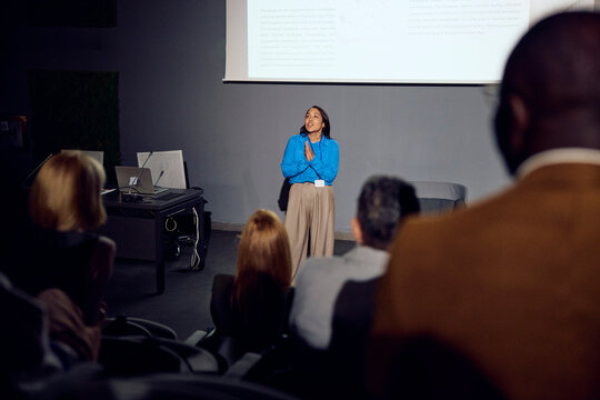 Woman speaks at a forum