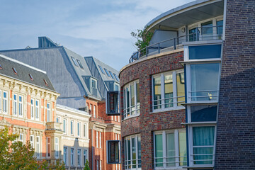 Fototapeta premium Curved building facade with box like attachments where pigeons perch.