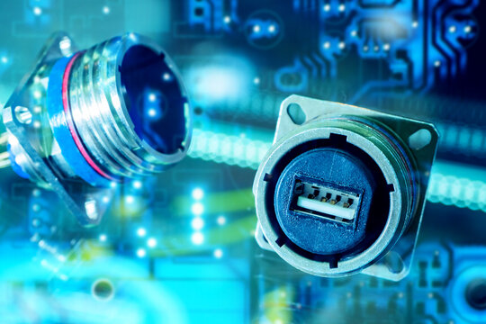 Electronics manufacturing, connectors. Industrial circular USB socket and plug on circuit background, used for data transfer, power supply, embedded systems and rugged equipment interfaces.